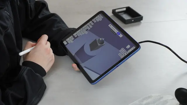 CAD model of the custom enclosure on a tablet screen